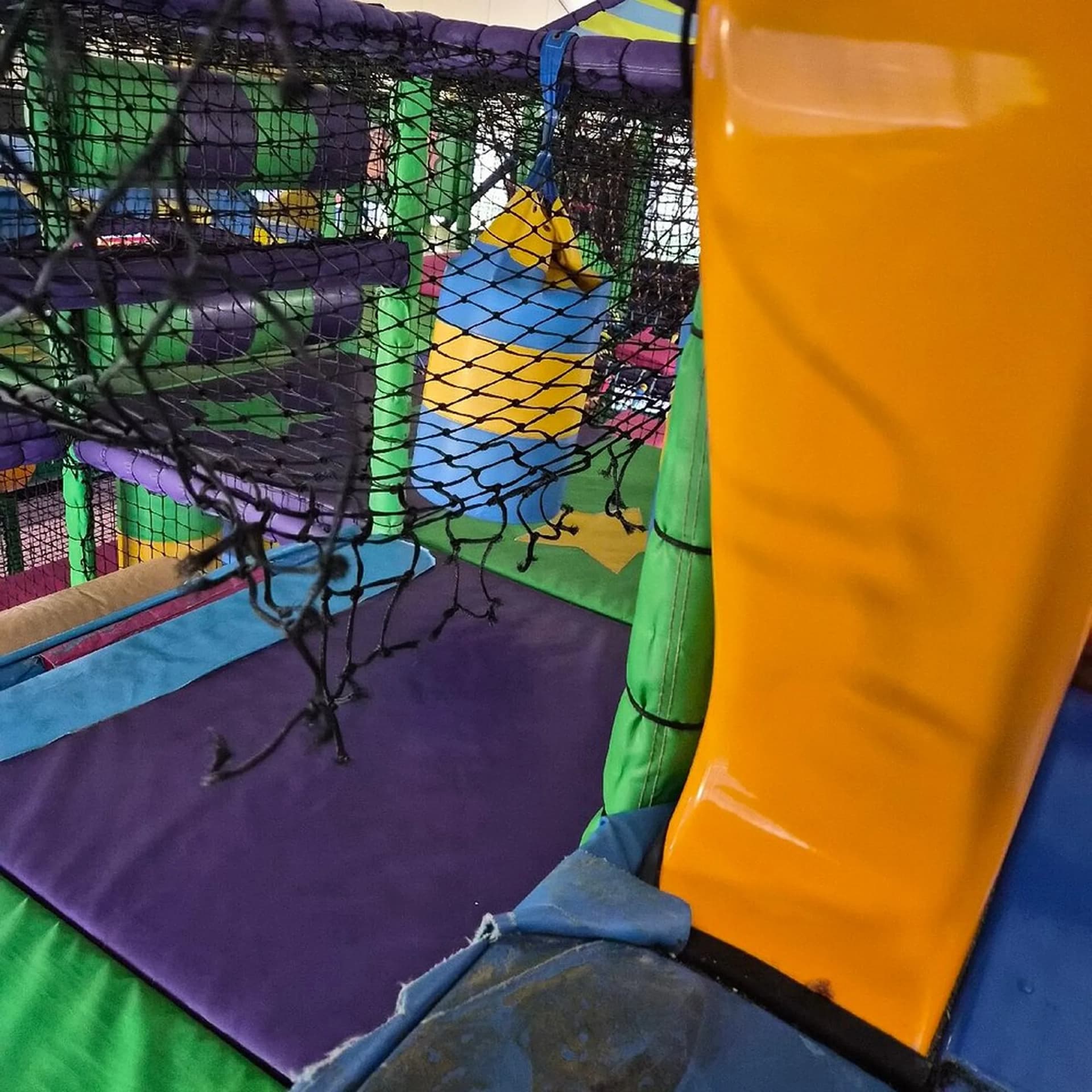 Damaged netting inside an indoor soft play frame