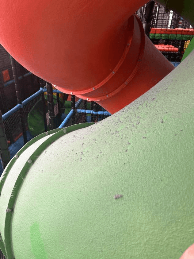 Dirty green GRP tube with scuffs and debris before a maintenance visit