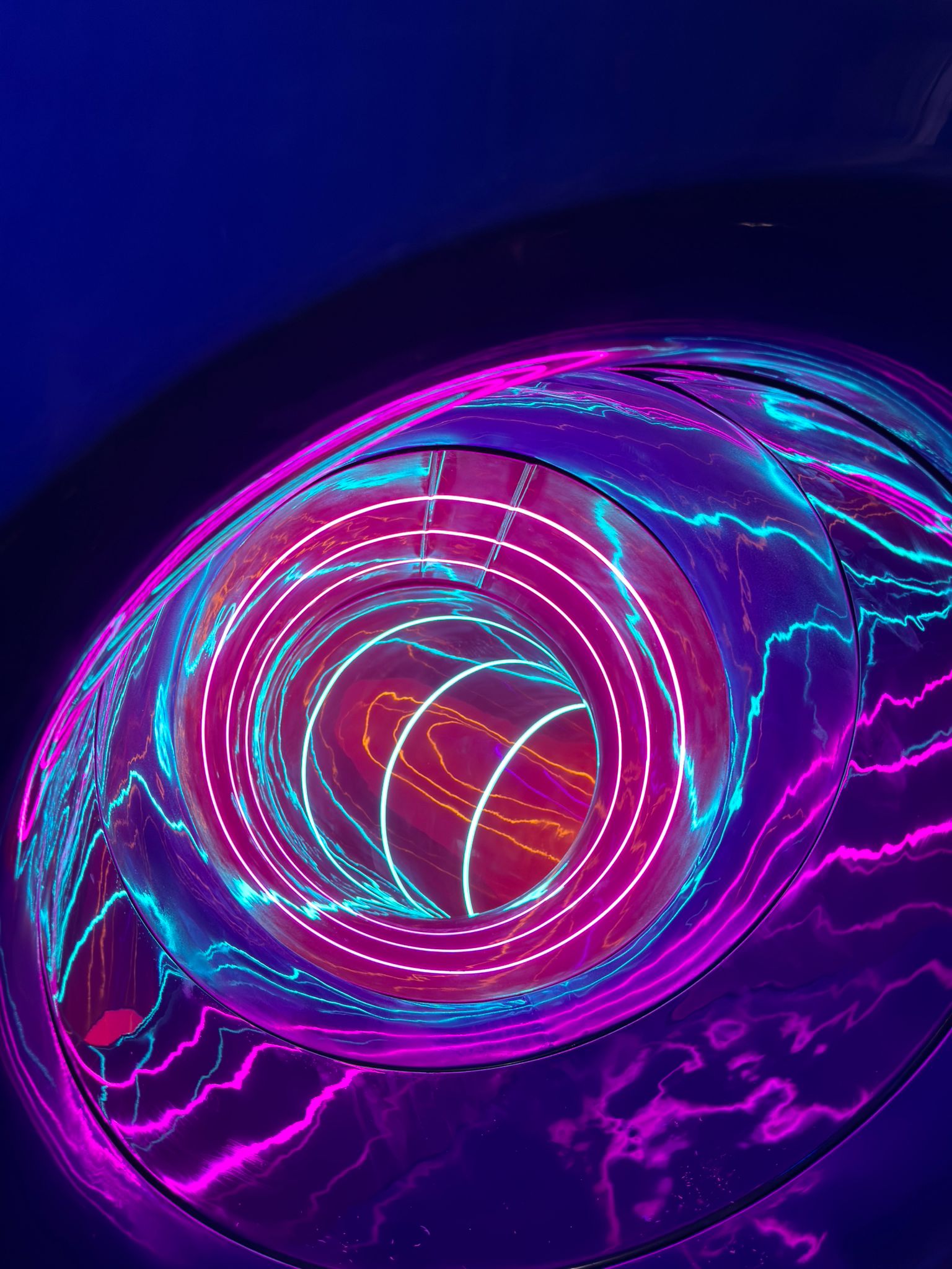 Top-down view into the GRP spiral with magenta and cyan LED lighting